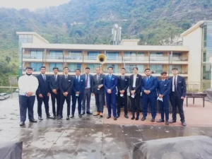 Students in suits on a balcony at Servo Institute.